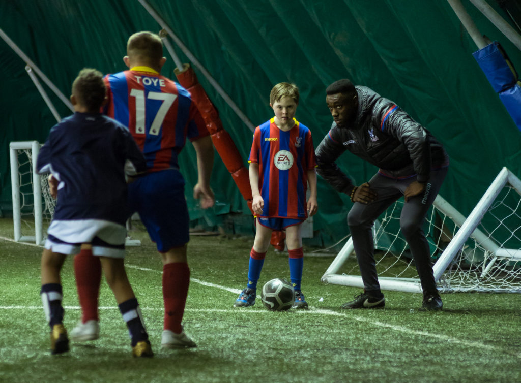 Disability Officer Keon Richardson talking to Ruairi during the DS Eagles' match against Millwall DS Lions